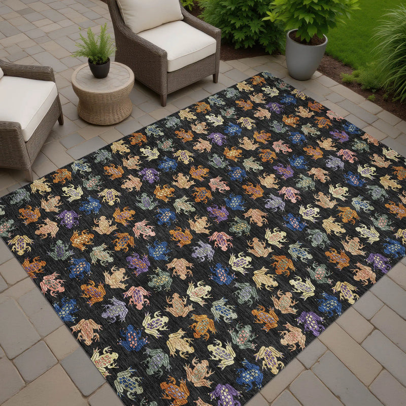 Vibrant outdoor rug featuring colorful frogs on a black background, perfect for patios and garden spaces.