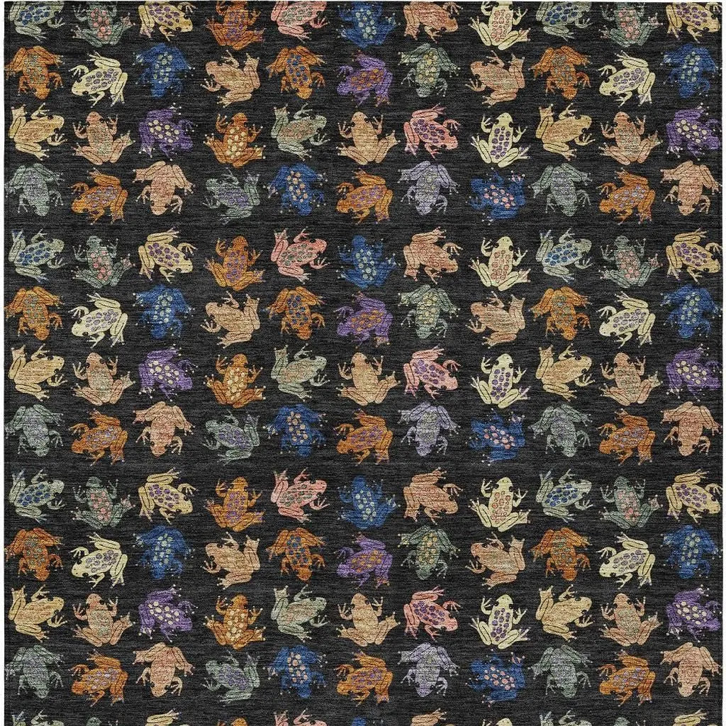 Colorful patterned fabric featuring frogs in various hues on a black background, ideal for DIY crafts and apparel.