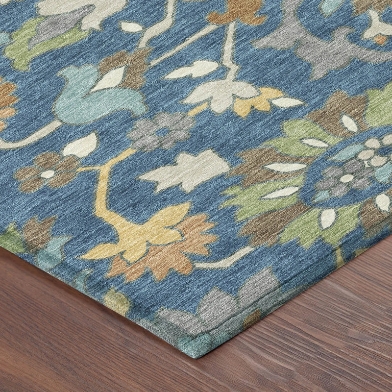 Blue floral area rug with multicolored patterns, featuring soft fibers and a contemporary design on wooden floor.