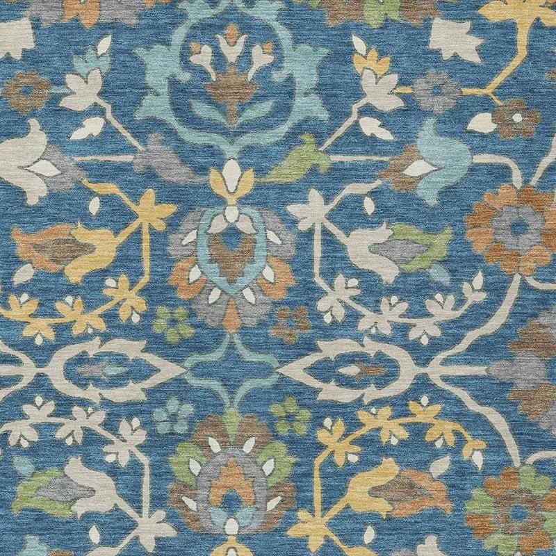 Multicolor floral area rug in blue, featuring intricate patterns in shades of green, yellow, and beige.