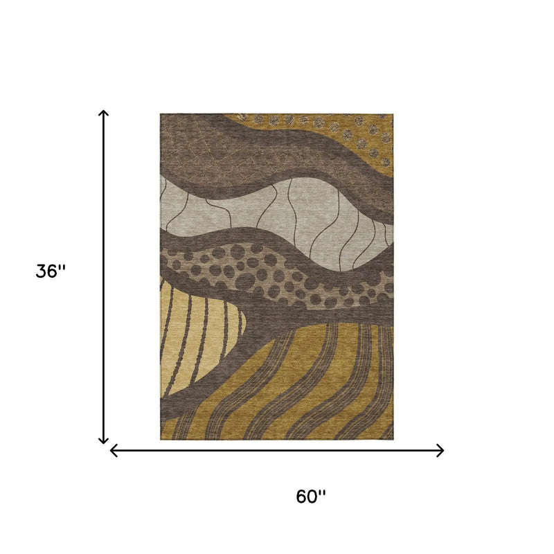 Abstract beige, gold, and brown area rug, 36x60 inches, featuring wavy patterns and textured design.