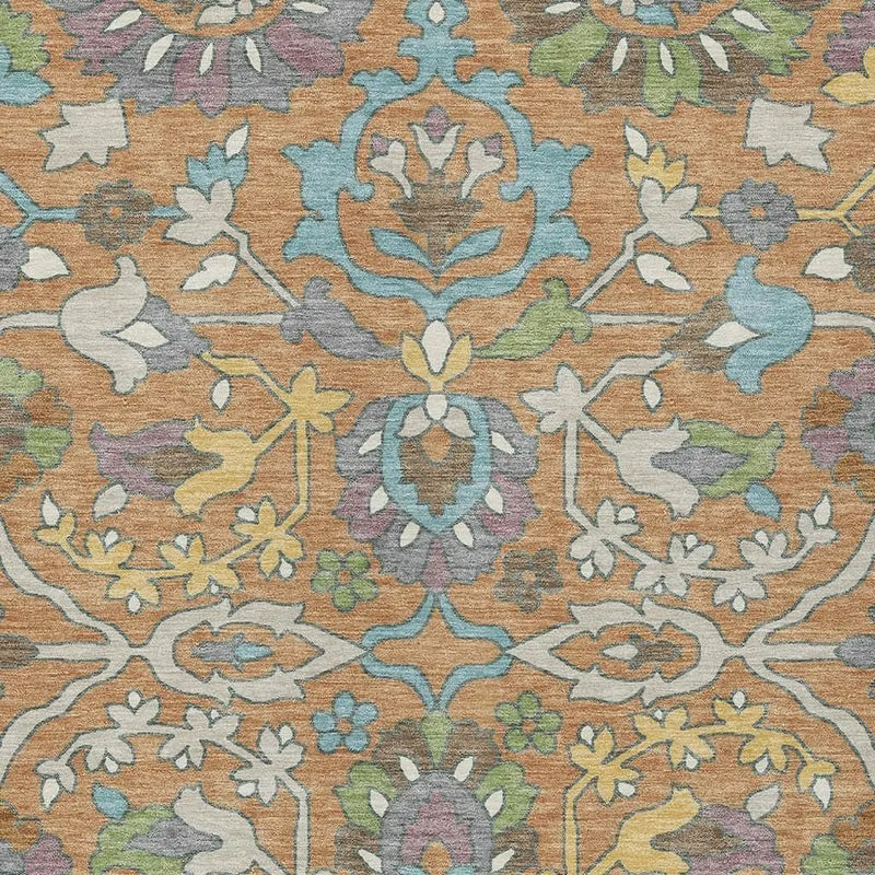 Stylish orange floral area rug with multicolored designs in blue, green, and lavender, perfect for modern decor.