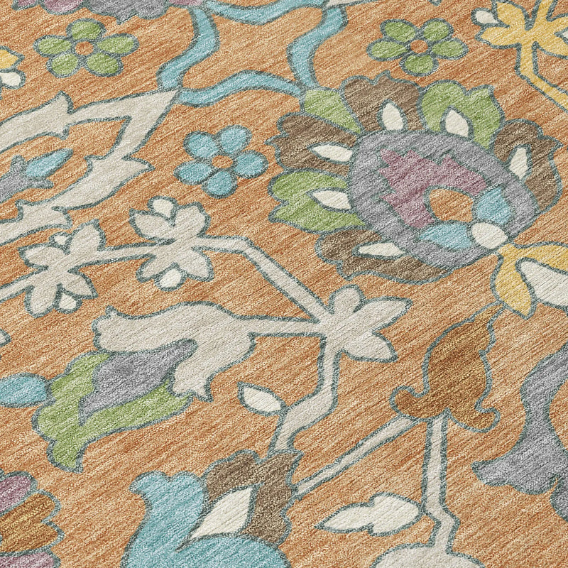 Colorful floral patterned area rug in orange, blue, and green hues, made of soft, durable synthetic fibers.