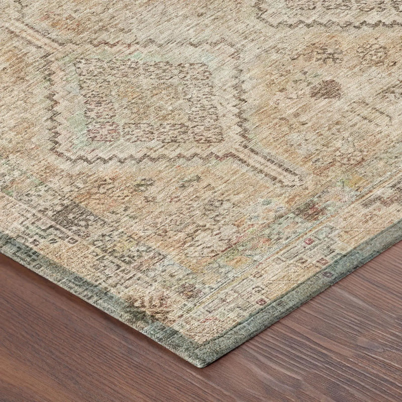 Antique-inspired beige area rug with intricate patterns, featuring subtle green and gray accents on a wooden floor.