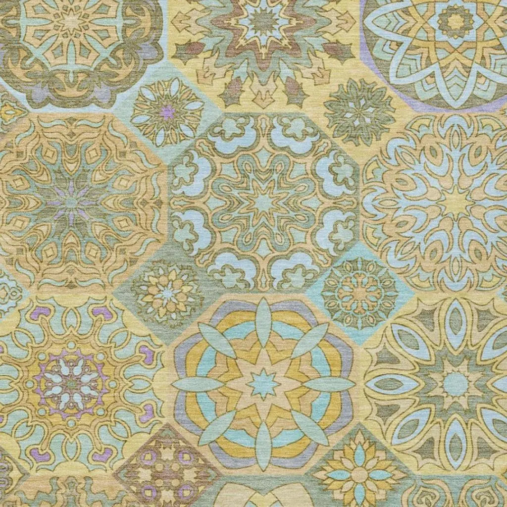 Colorful geometric patterned fabric in soft pastels and gold, perfect for upholstery or home decor projects.