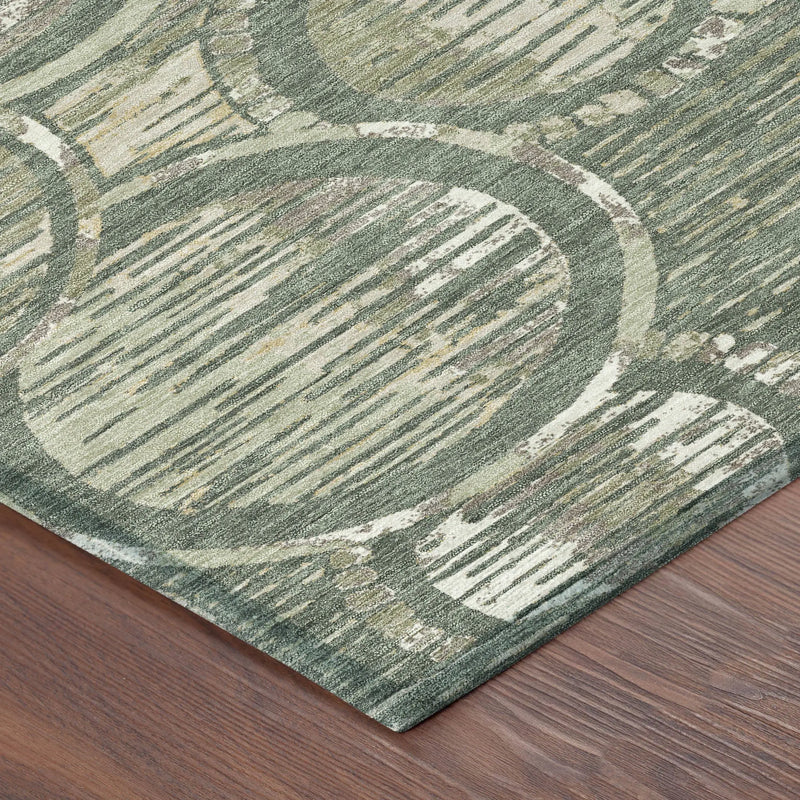 Green abstract area rug with circular patterns, made of soft synthetic fibers, on a wooden floor.