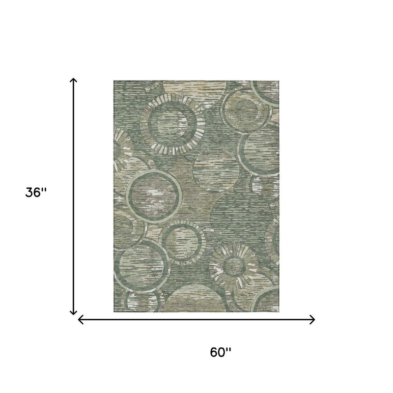 Green abstract circular pattern area rug, 36"x60", made of durable polyester for modern home decor.