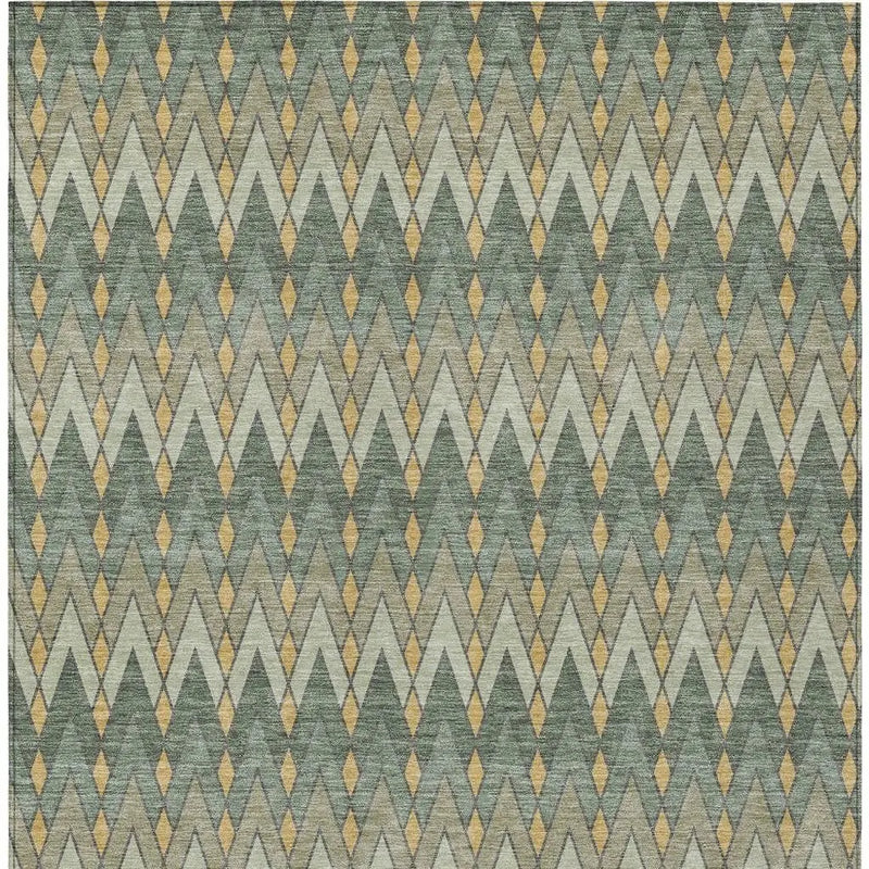 Geo-patterned area rug in muted greens, beige, and gold, featuring a modern diamond design, perfect for contemporary decor.