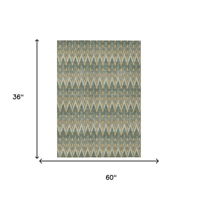 Geometric area rug in teal and gold, 60"x36", featuring a modern zigzag pattern on a soft fabric.