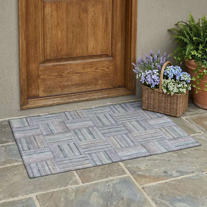 Multicolored woven doormat in gray and purple, featuring a stylish plaid design, perfect for welcoming guests.