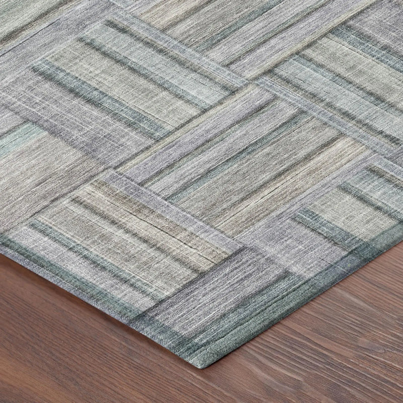 Multicolor geometric area rug in gray and teal, made of soft synthetic fibers, perfect for modern interiors.