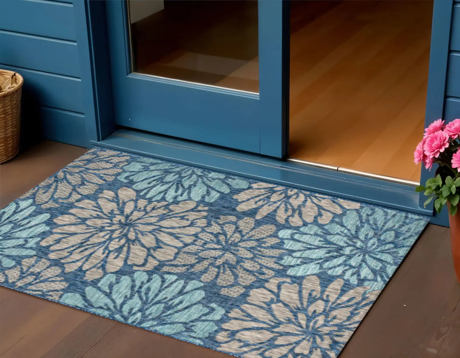 Blue floral patterned outdoor rug, made of durable material, perfect for entryways.