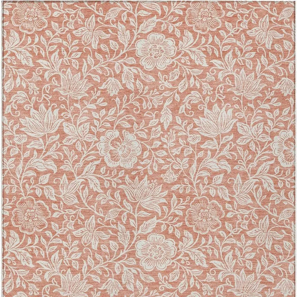 Rustic coral floral patterned fabric with white intricate designs, perfect for home decor or upholstery projects.