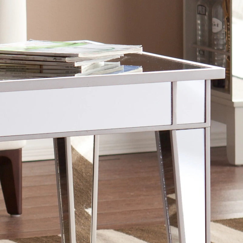 Modern white mirrored coffee table with sleek chrome accents, perfect for contemporary living spaces.