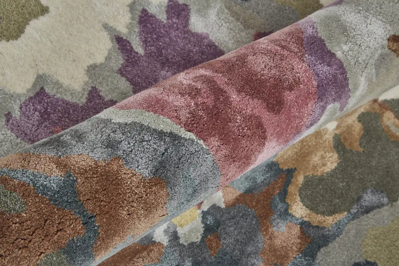 Colorful abstract plush rug with pink, purple, brown, and green patterns on a cream background. Soft, modern design.