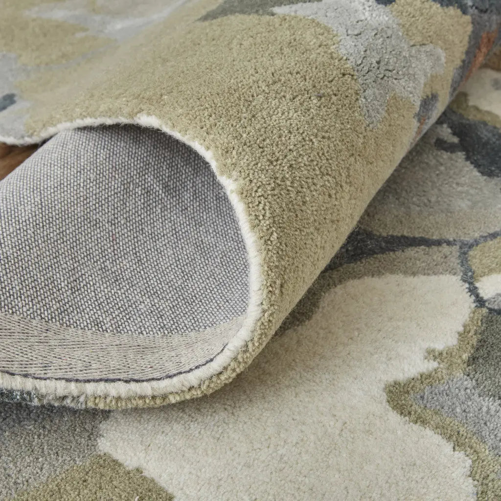 Soft, plush green and beige floral rug with a grey backing, perfect for modern or rustic home decor.