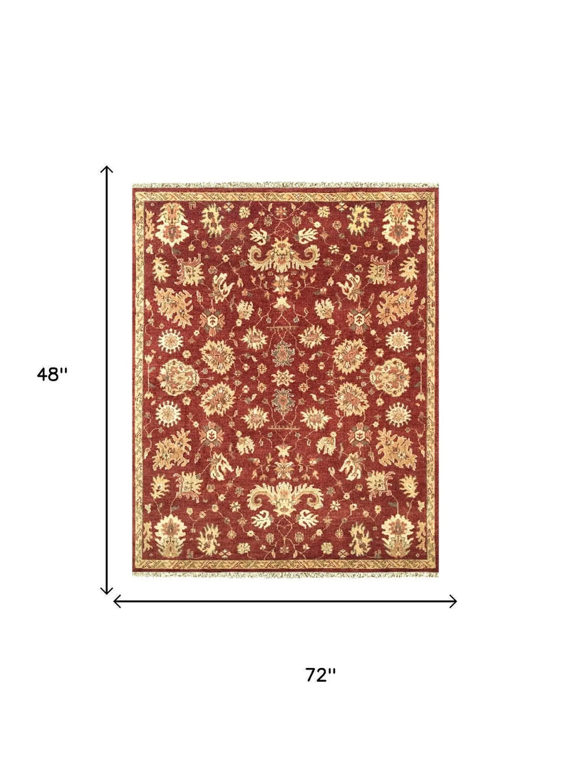 Red and gold floral area rug, 72"x48", traditional style, soft polypropylene material, perfect for living rooms.