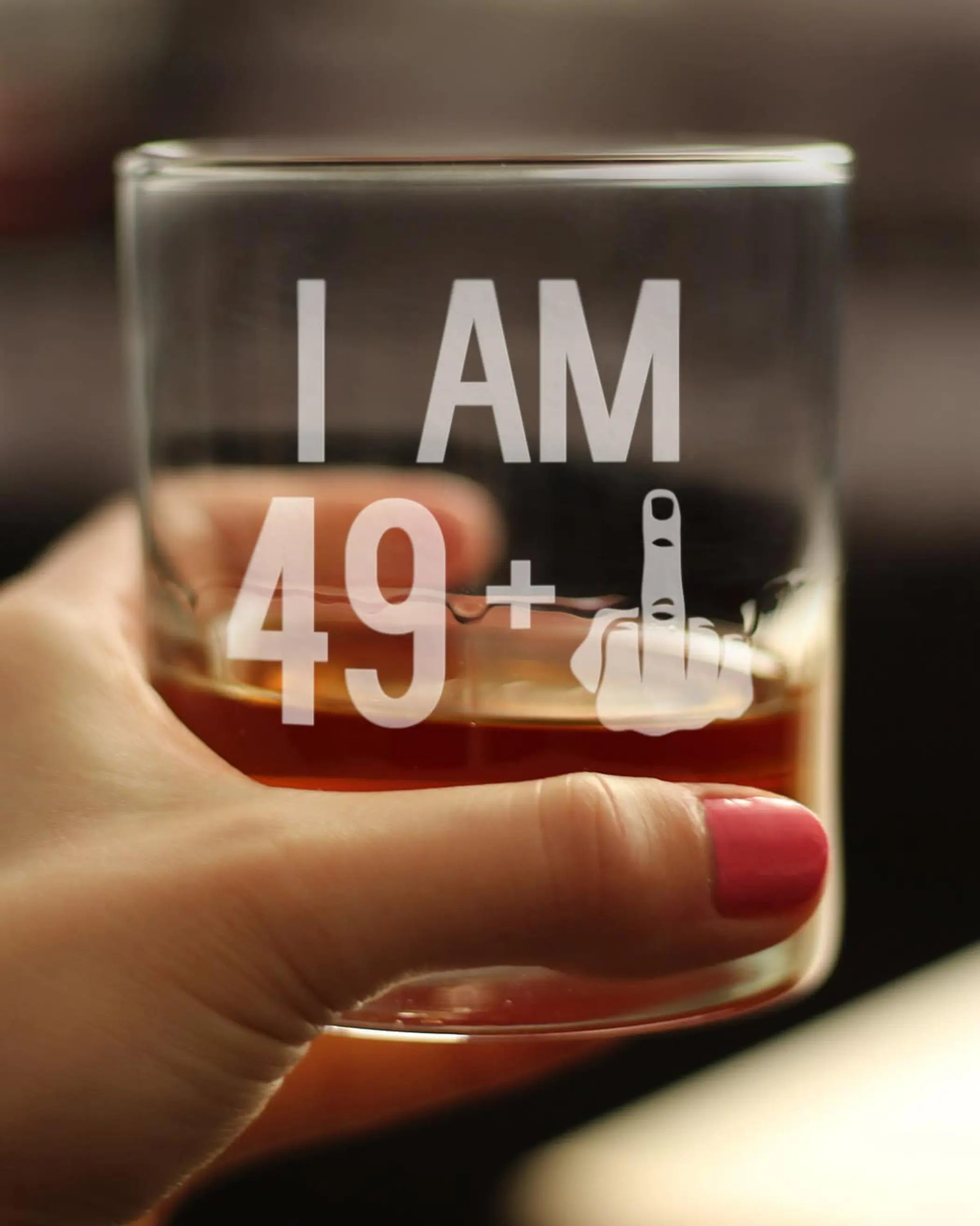 Clear glass whiskey tumbler with white lettering "I AM 49+" and a hand gesture, perfect for birthday celebrations.