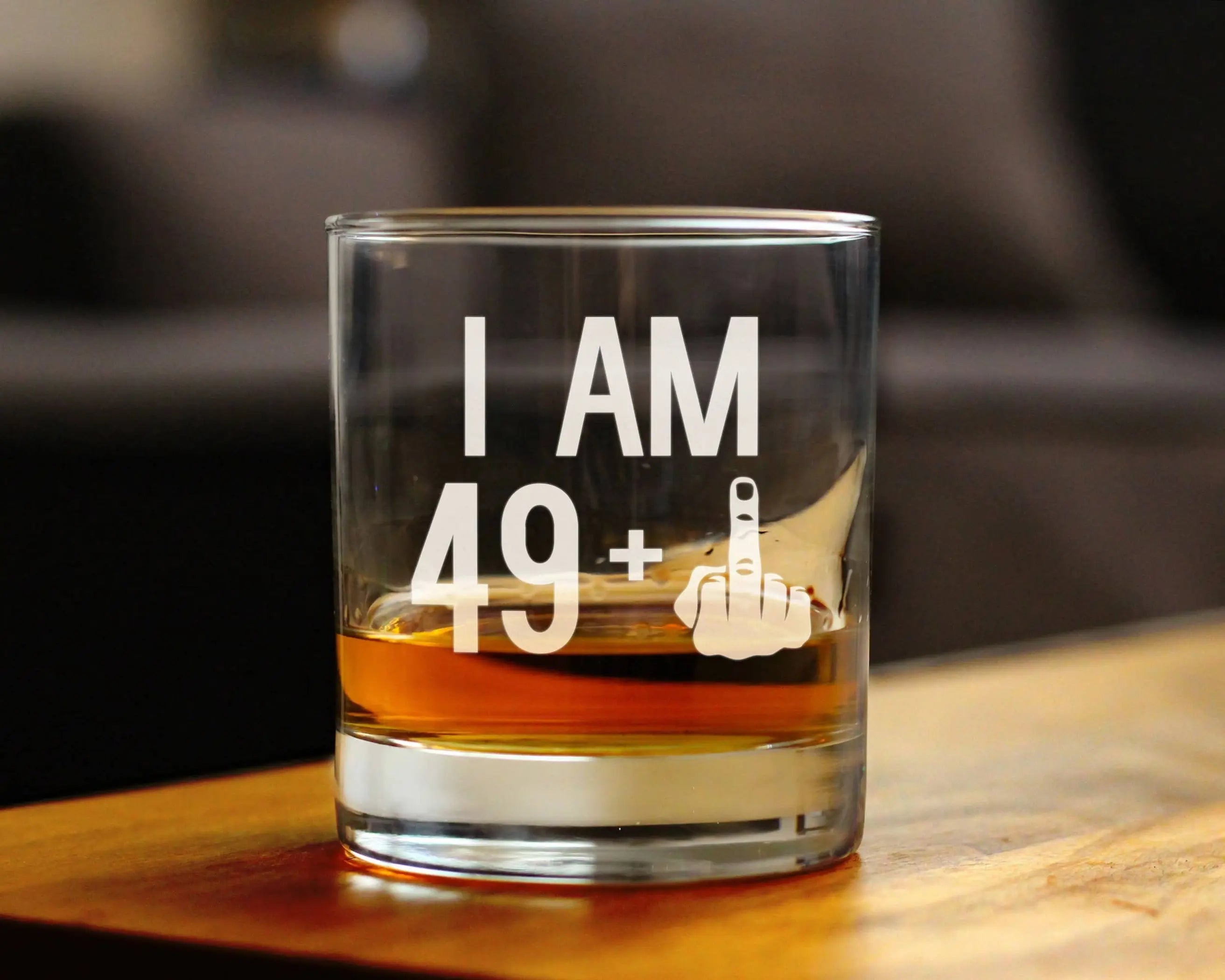 Clear whiskey glass featuring bold "I AM 49+" text and a middle finger graphic, perfect for spirited celebrations.