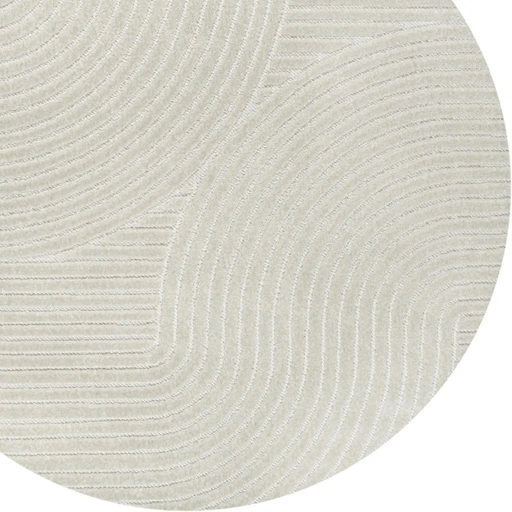 Beige circular rug with textured wave pattern, perfect for modern and minimalist home decor.