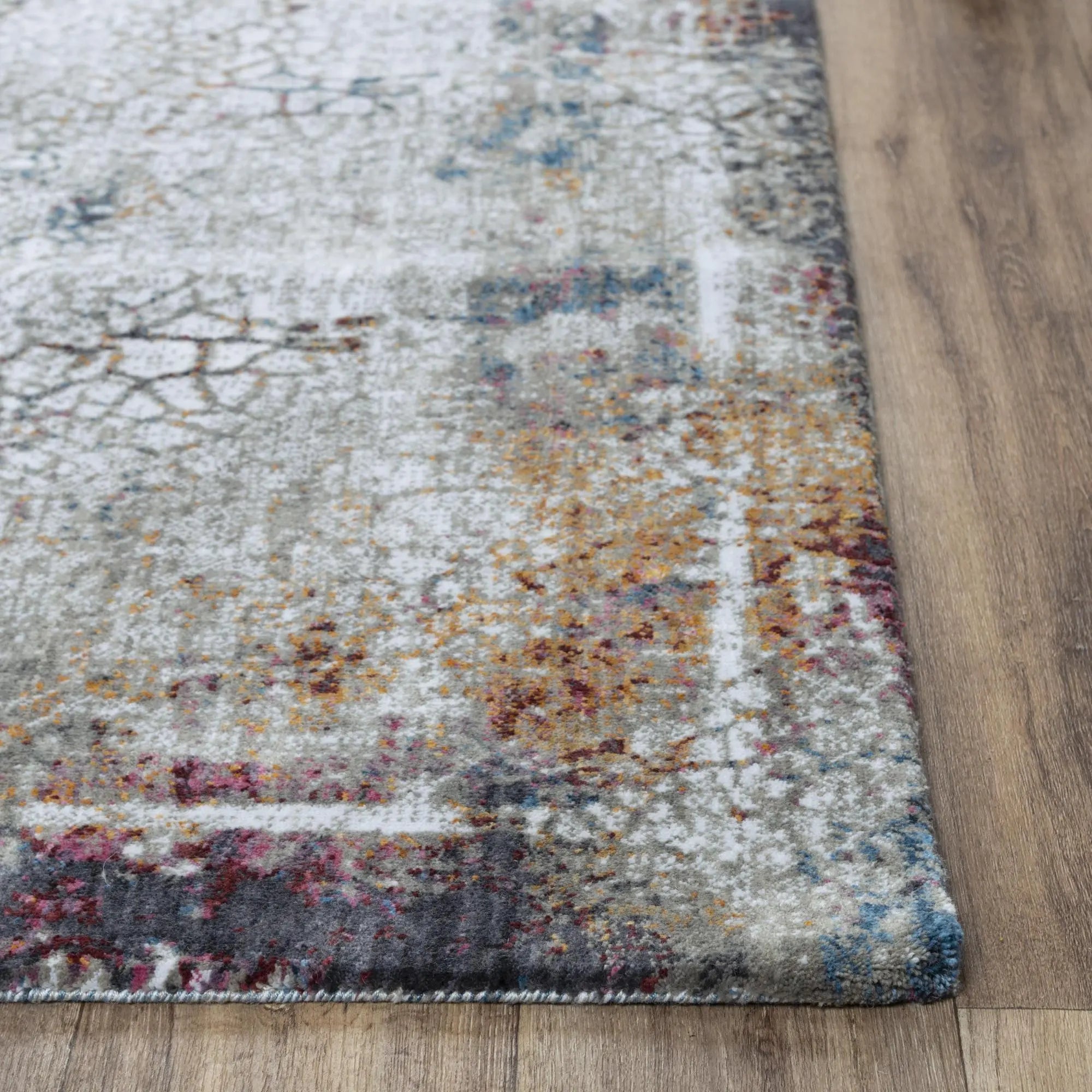 Multicolor abstract area rug with gray, blue, and orange hues, featuring a soft plush pile and modern design.