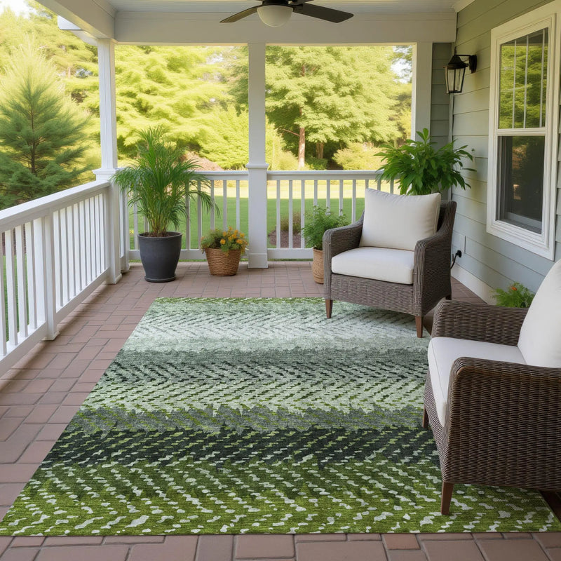 Green geometric outdoor rug, made of durable synthetic fibers, perfect for patio decor.
