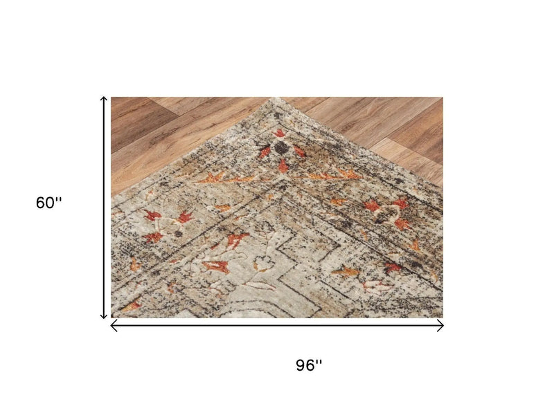 Vintage-style area rug in beige, orange, and brown, measuring 60" x 96", featuring floral and geometric patterns.