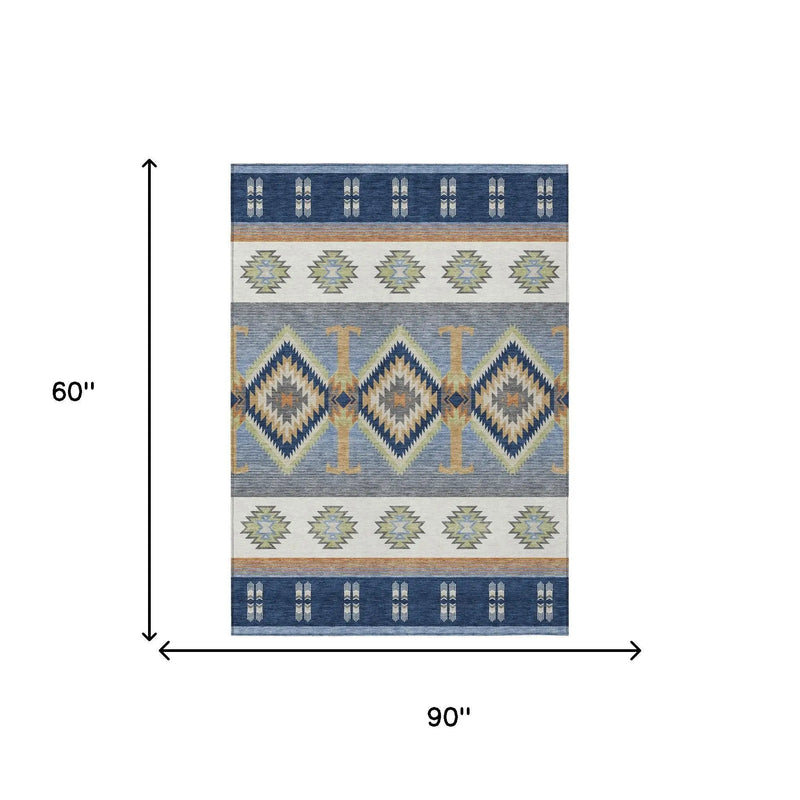 Navy blue and cream geometric patterned area rug, 90"x60", woven with durable synthetic fibers.