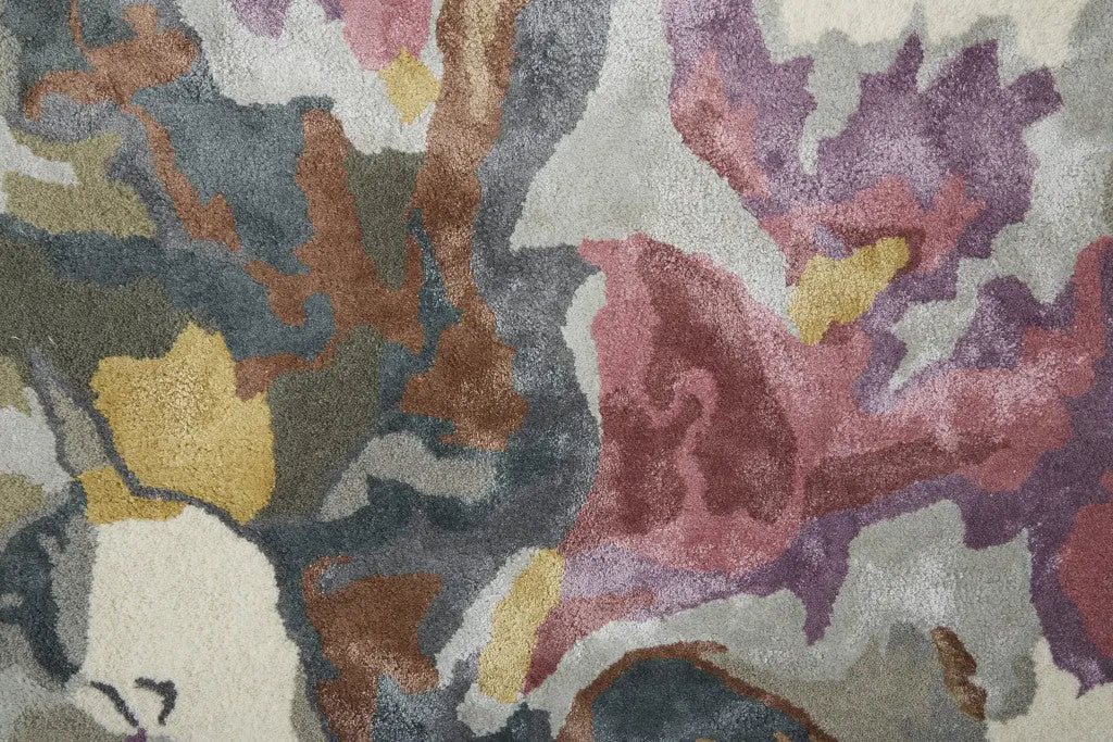 Multicolor abstract area rug in plush, soft fibers featuring shades of grey, pink, yellow, and cream for a vibrant decor.