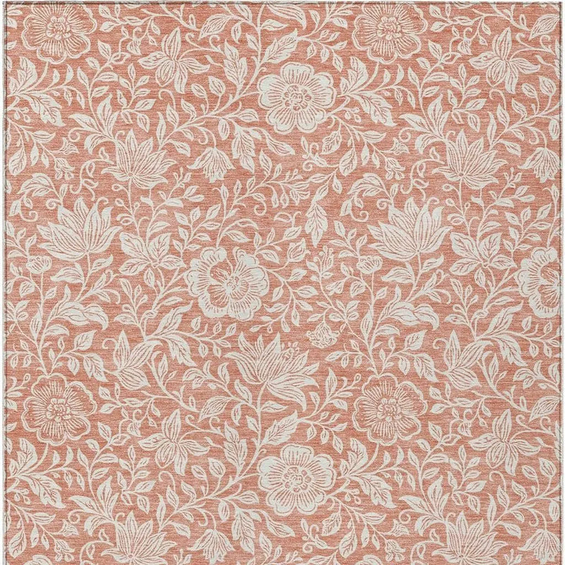 Rust floral patterned fabric in coral orange and cream, perfect for home décor and upholstery projects.