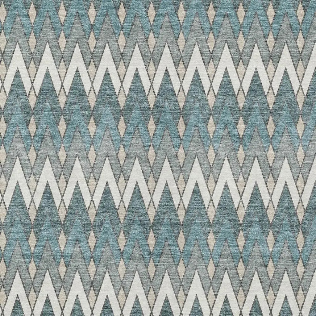 Geometric teal, gray, and white patterned fabric with zigzag and diamond motifs, perfect for modern upholstery.