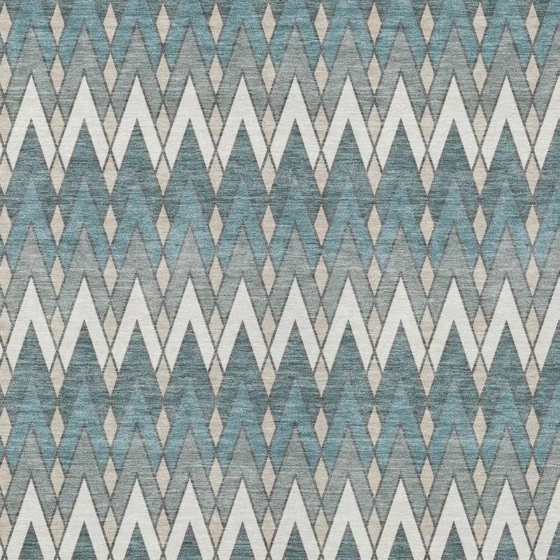 Geometric teal, gray, and white patterned fabric with zigzag and diamond motifs, perfect for modern upholstery.