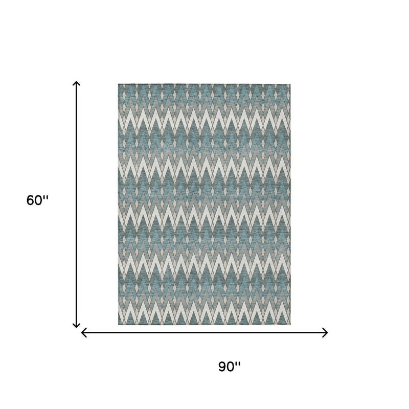 Blue and ivory geometric pattern area rug, 90x60 inches, woven in durable indoor-outdoor material.