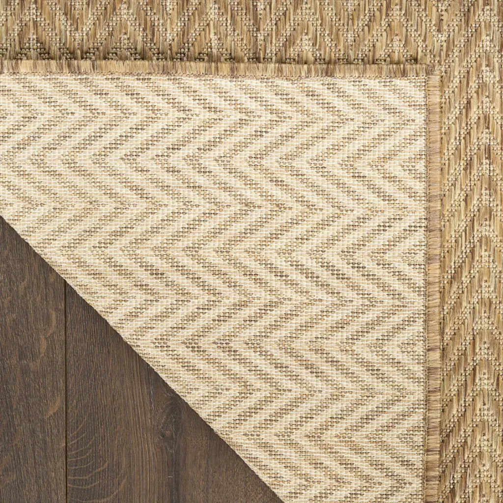 Natural woven rug with a beige chevron pattern and a textured edge, featuring earthy tones perfect for modern decor.