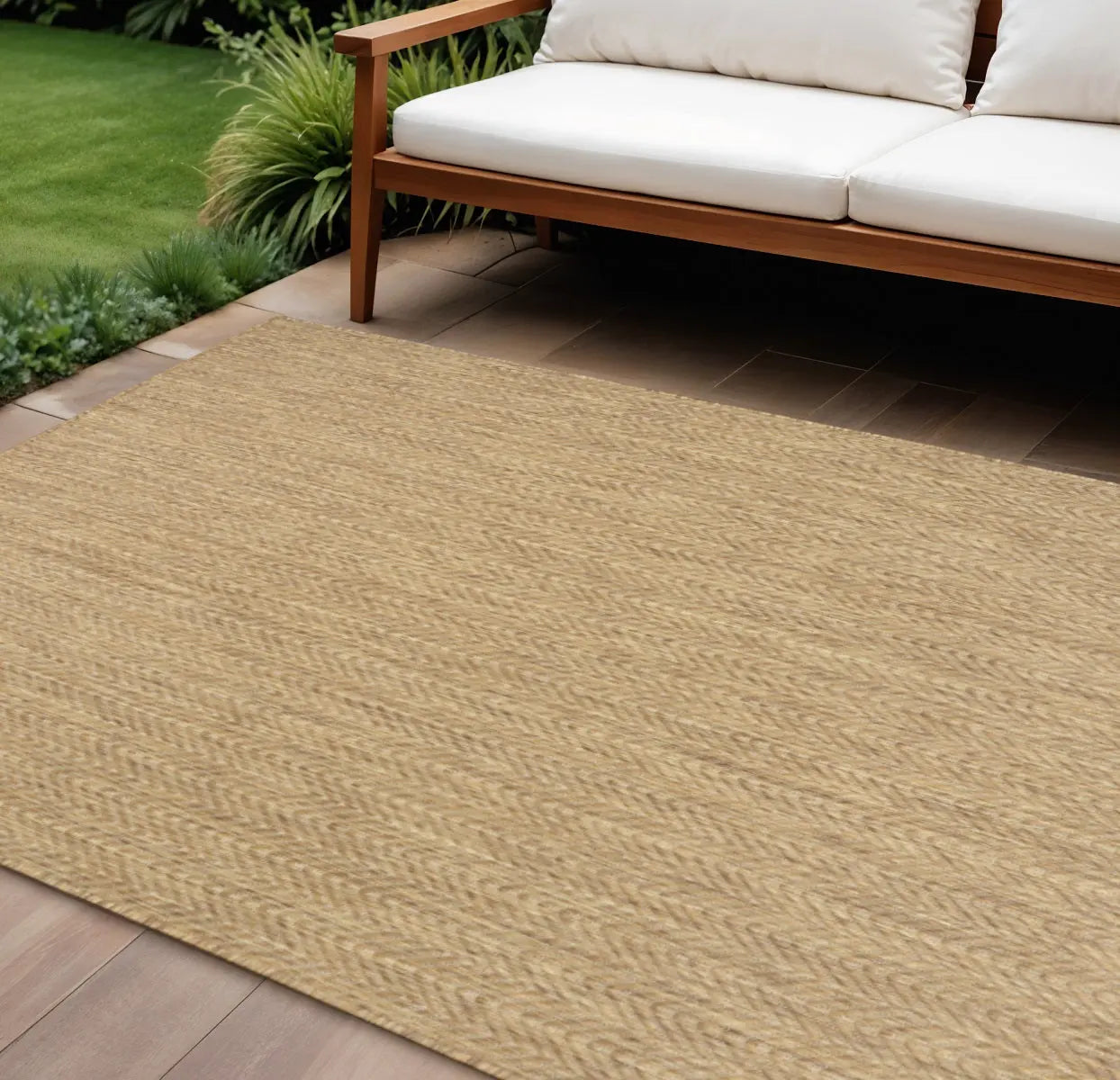 Natural jute area rug in warm beige, featuring a woven herringbone texture, perfect for outdoor spaces.