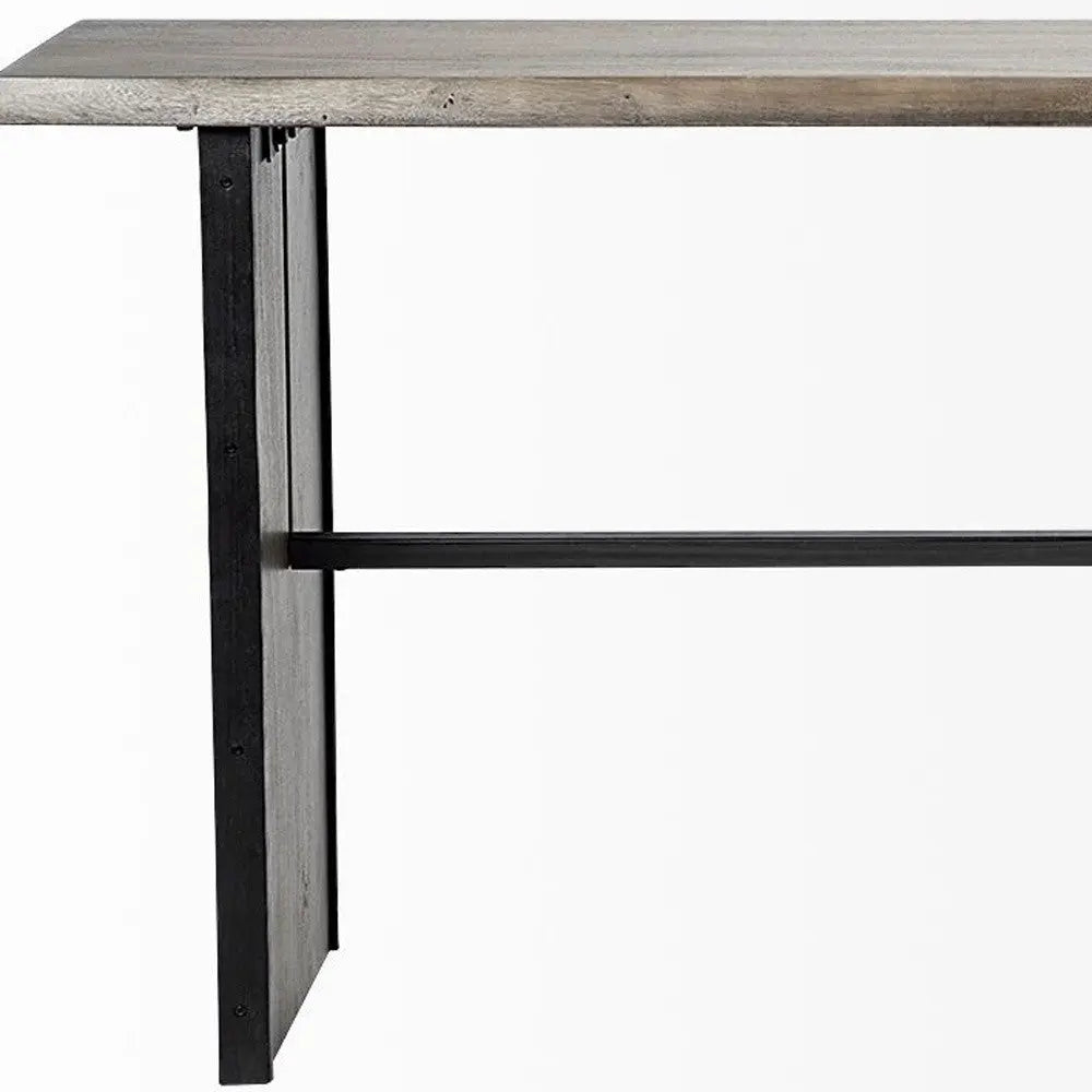 Industrial-style gray wooden table with black metal legs and crossbar support. Perfect for modern dining rooms.