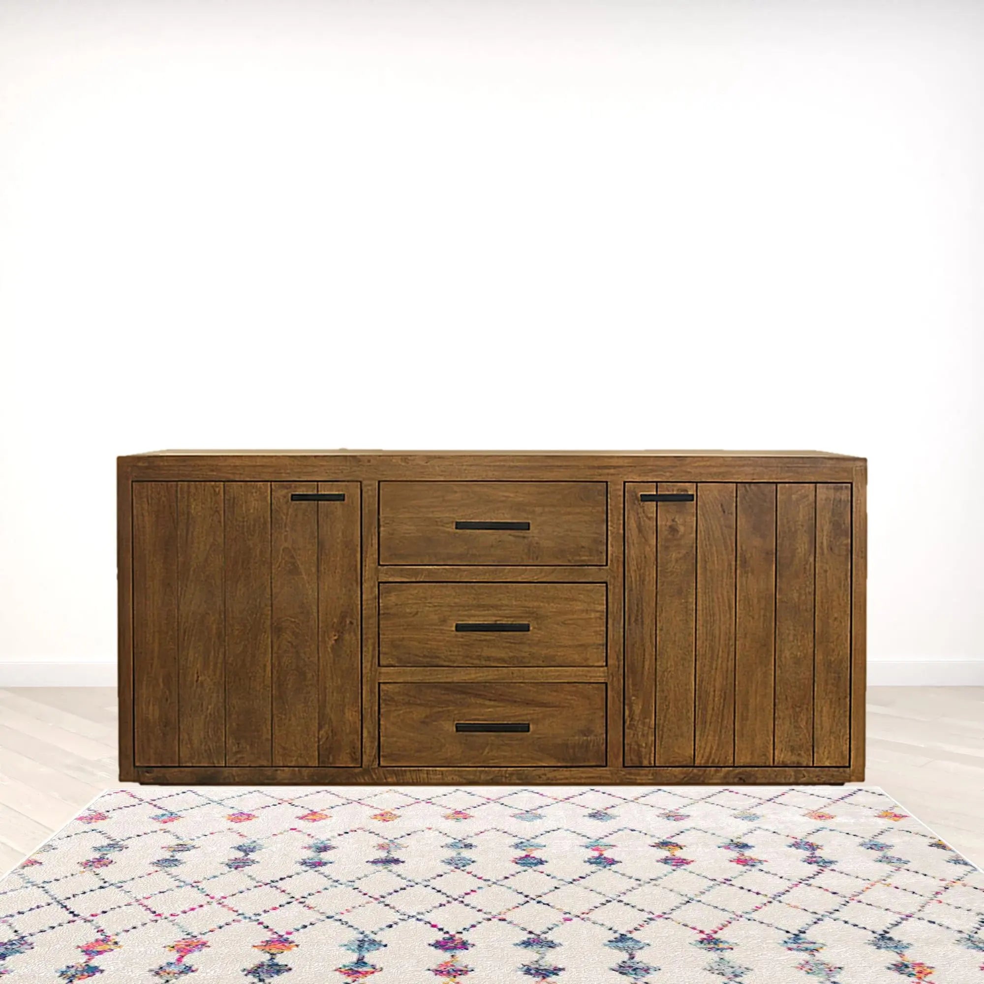 Rustic brown wooden sideboard with three drawers and two cabinets, accentuated by a patterned area rug.