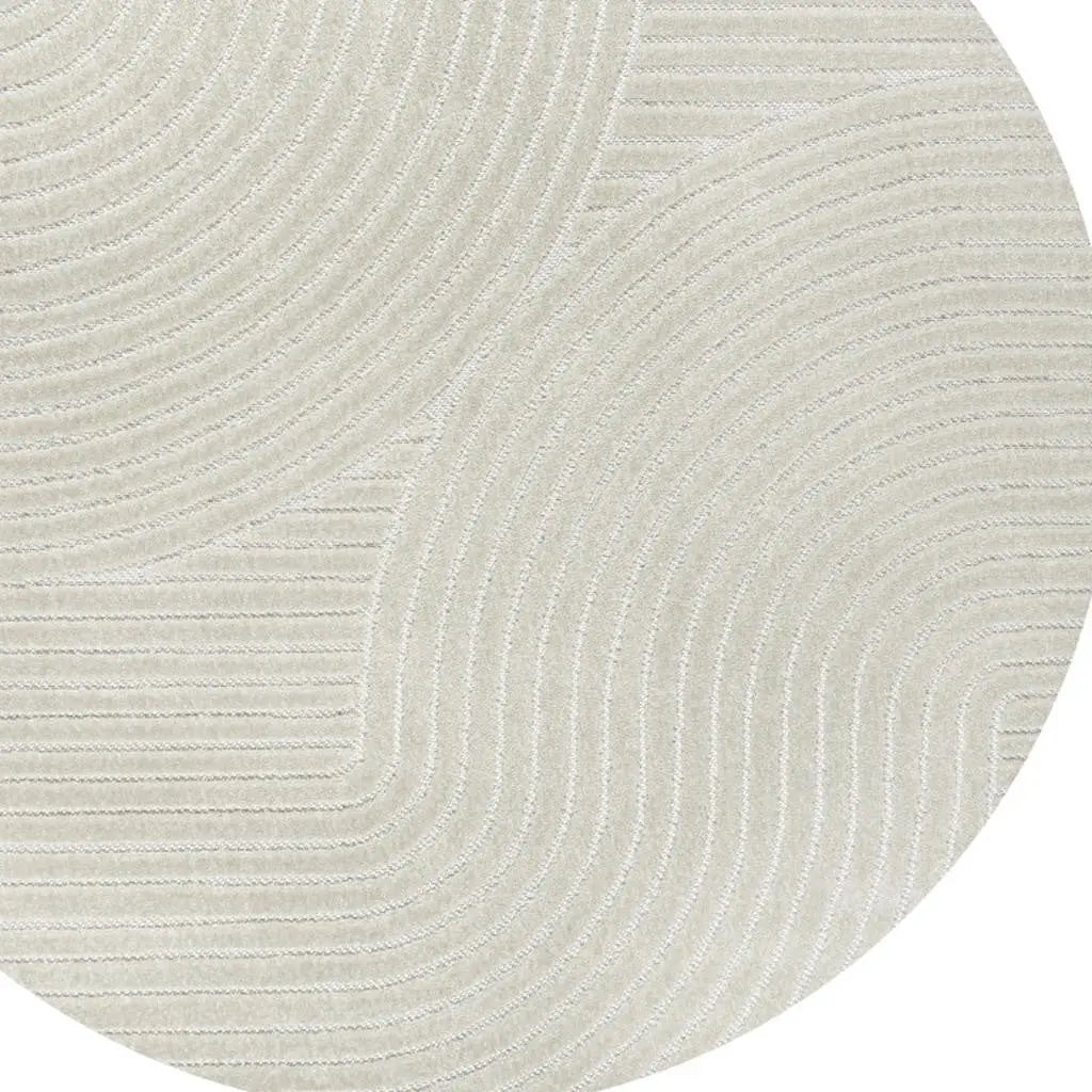 Cream circular rug with textured swirl pattern, made from soft polyester, perfect for modern and contemporary decor.