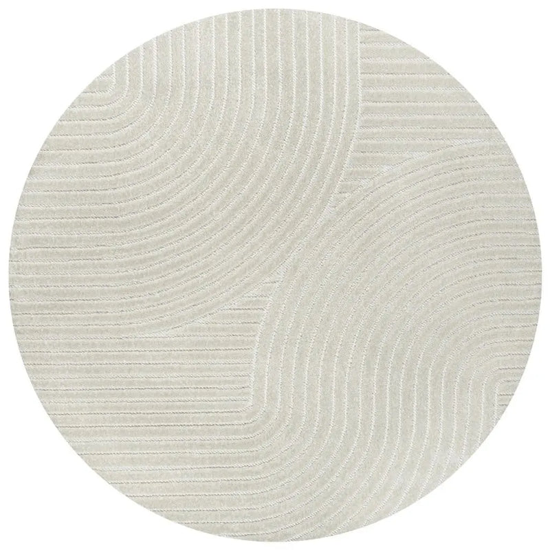 Round beige area rug with textured wave patterns, crafted from soft synthetic fibers for modern interiors.