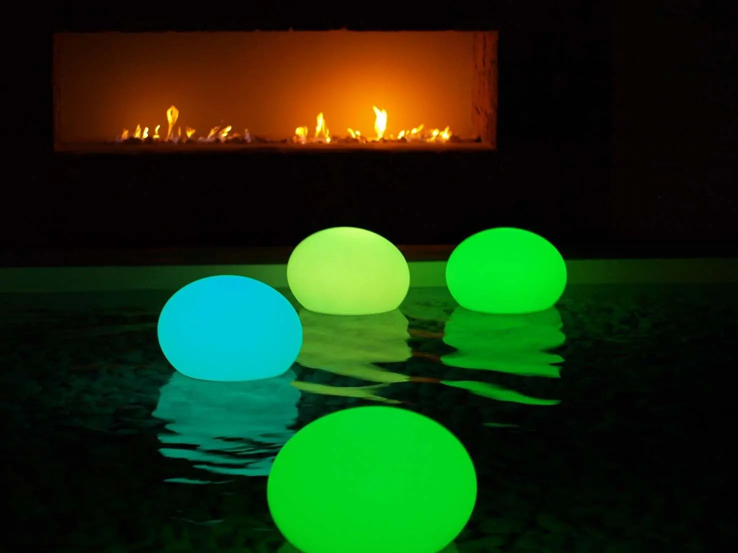 Colorful glowing floating eggs in a pool, featuring green and blue hues, perfect for ambiance and decoration.