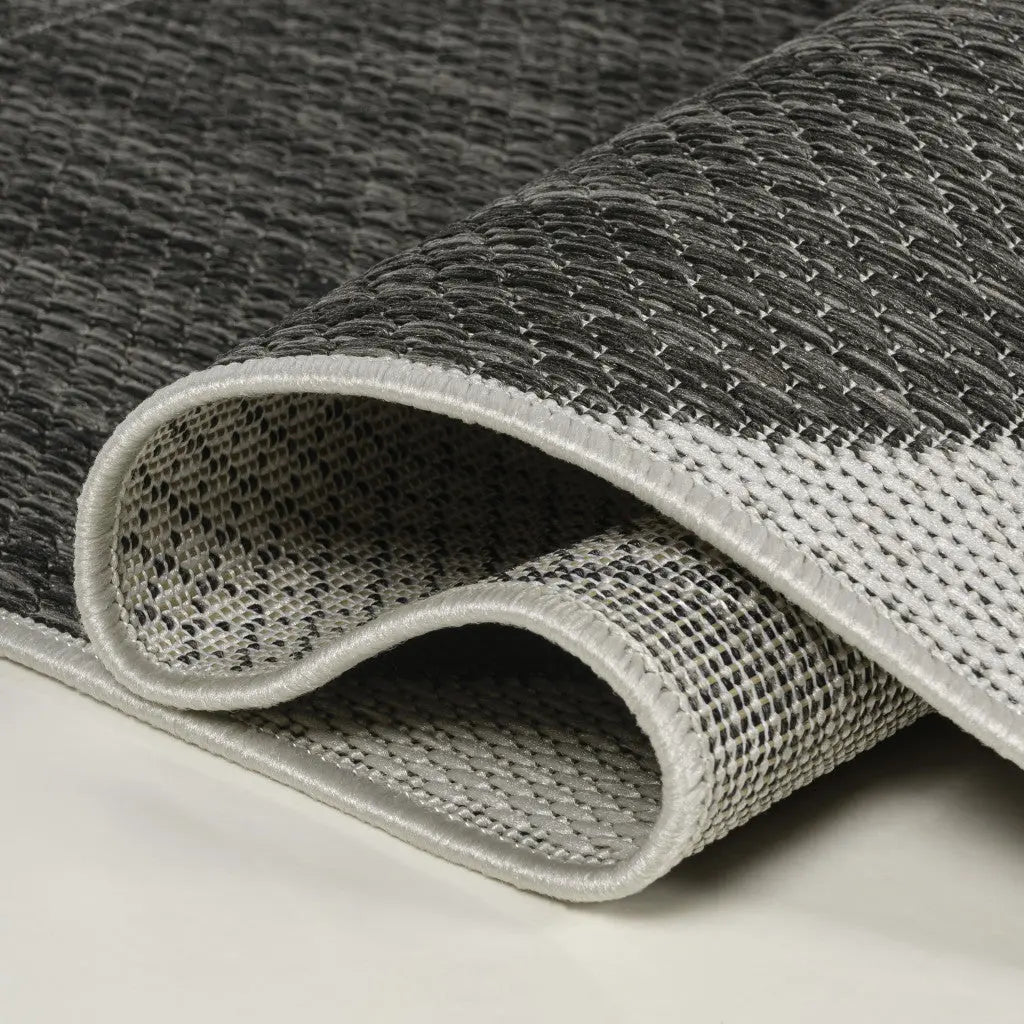 Gray and white woven area rug, featuring a textured pattern and durable material, perfect for modern home decor.