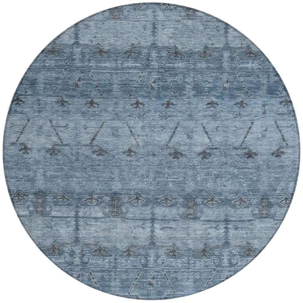 Round blue area rug featuring intricate patterns and a soft, plush texture, perfect for modern or rustic decor.