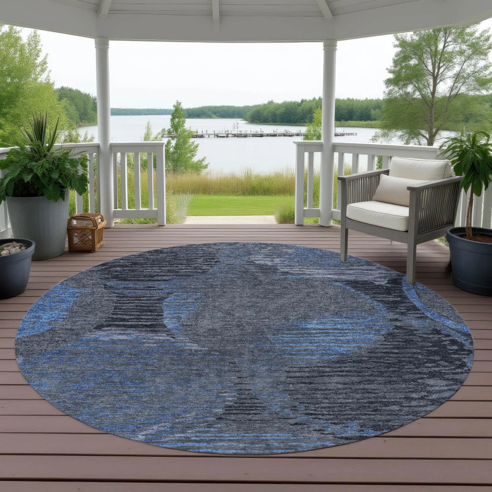 Round blue and gray indoor-outdoor rug in abstract design, perfect for patio or porch decor.