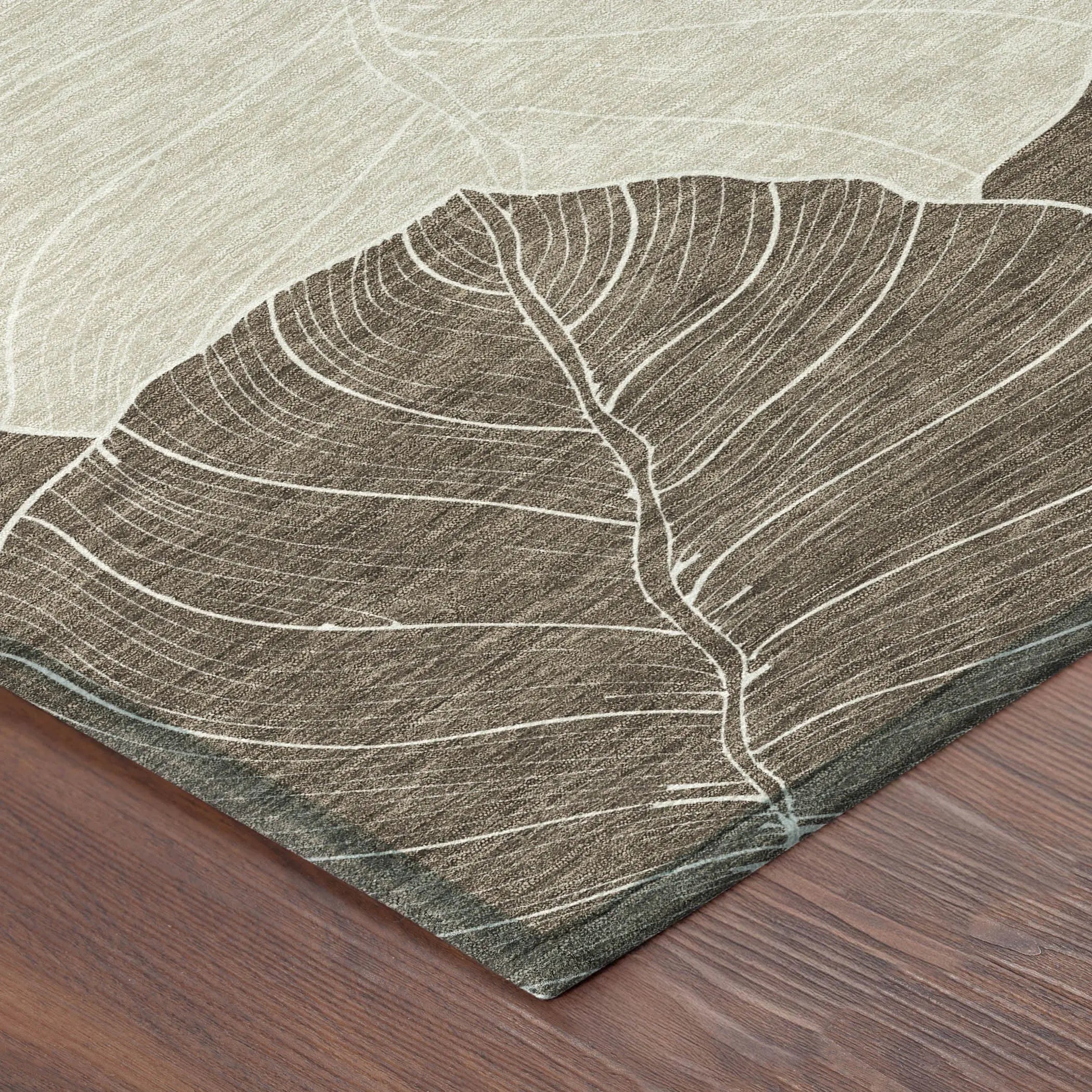 Beige and brown area rug with leaf design, textured fabric, perfect for modern home decor.