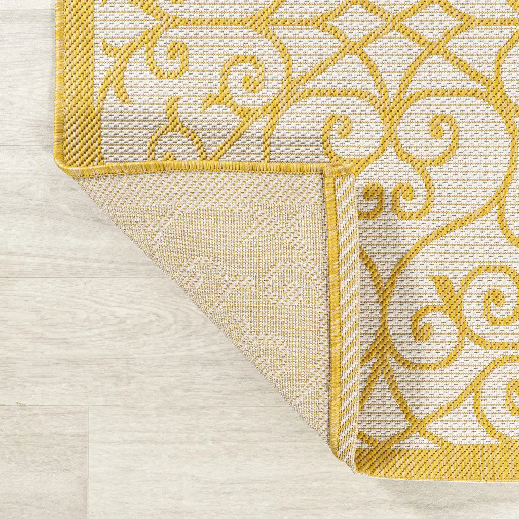 Yellow and gray floral patterned area rug in modern style, featuring durable woven synthetic material.