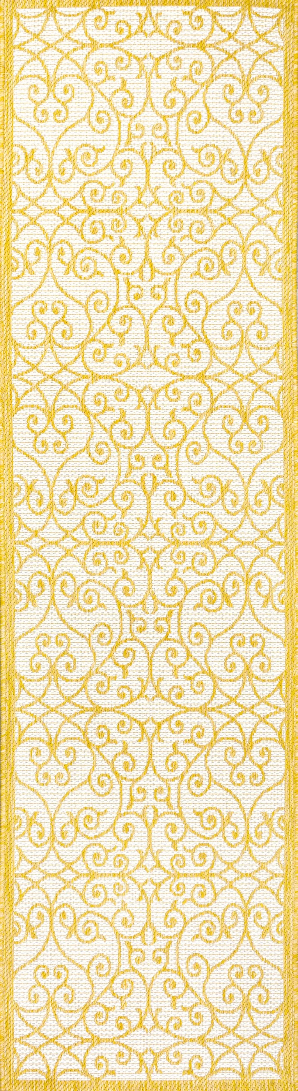 Elegant yellow patterned table runner on a white background, made of durable fabric, perfect for dining decor.