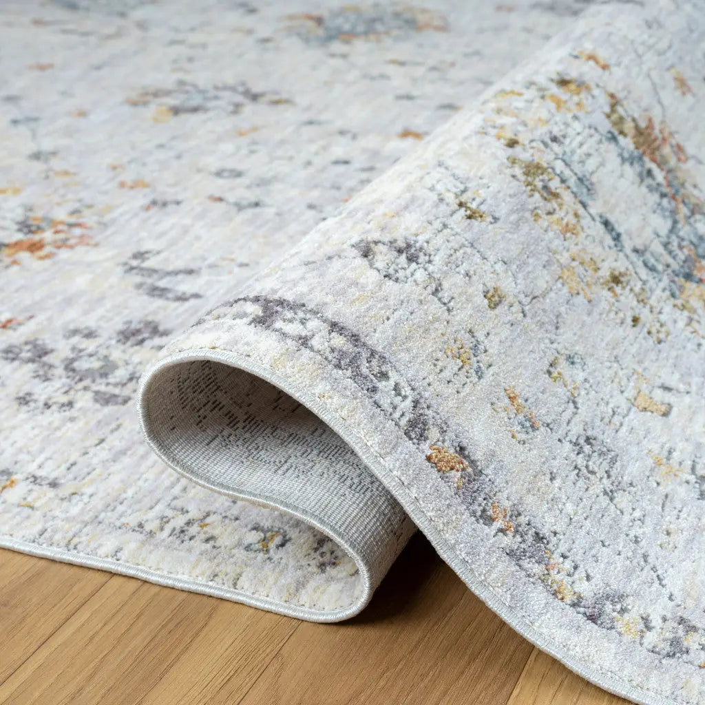 Light gray vintage-style area rug with multicolor accents, soft texture, and intricate pattern for modern decor.
