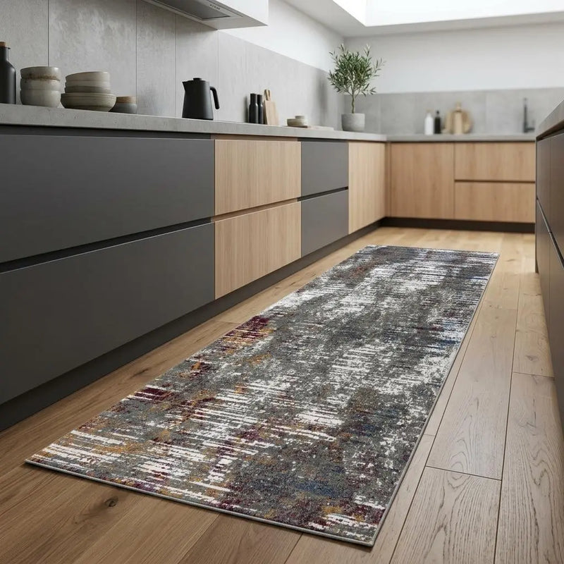 Modern grey abstract runner rug with hints of burgundy, perfect for kitchen or hallway, made from durable synthetic fibers.