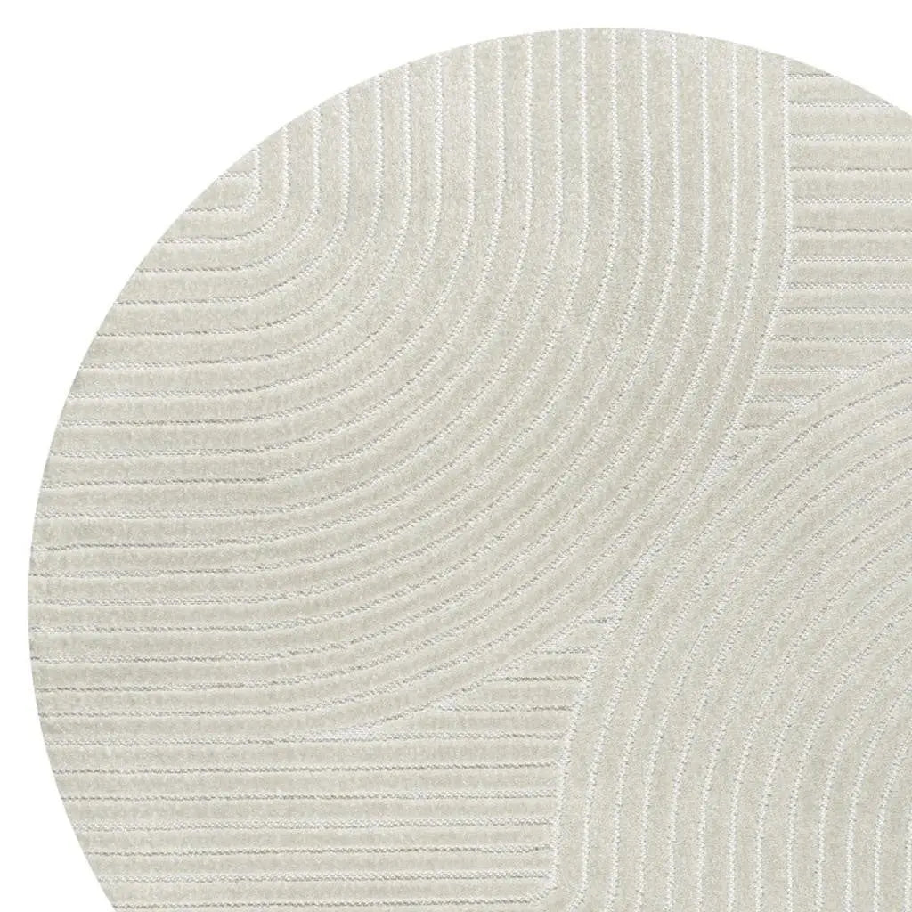 Textured round rug in soft beige with subtle circular patterns, perfect for modern and minimalist decor.