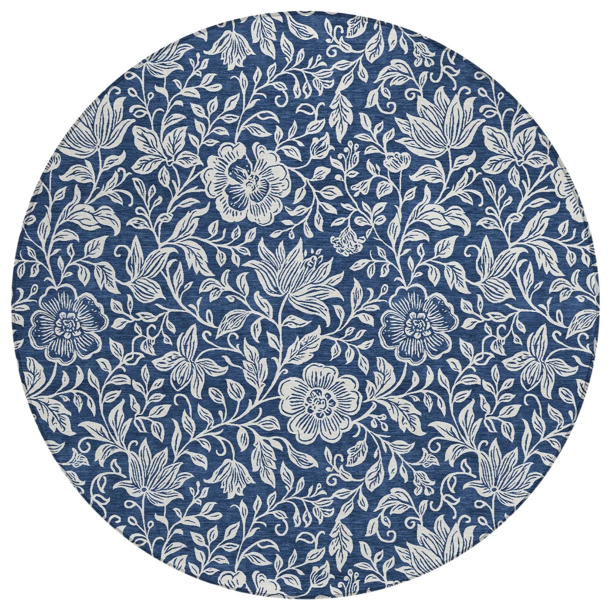 Round blue floral tablecloth featuring intricate white flower patterns in a classic vintage style.